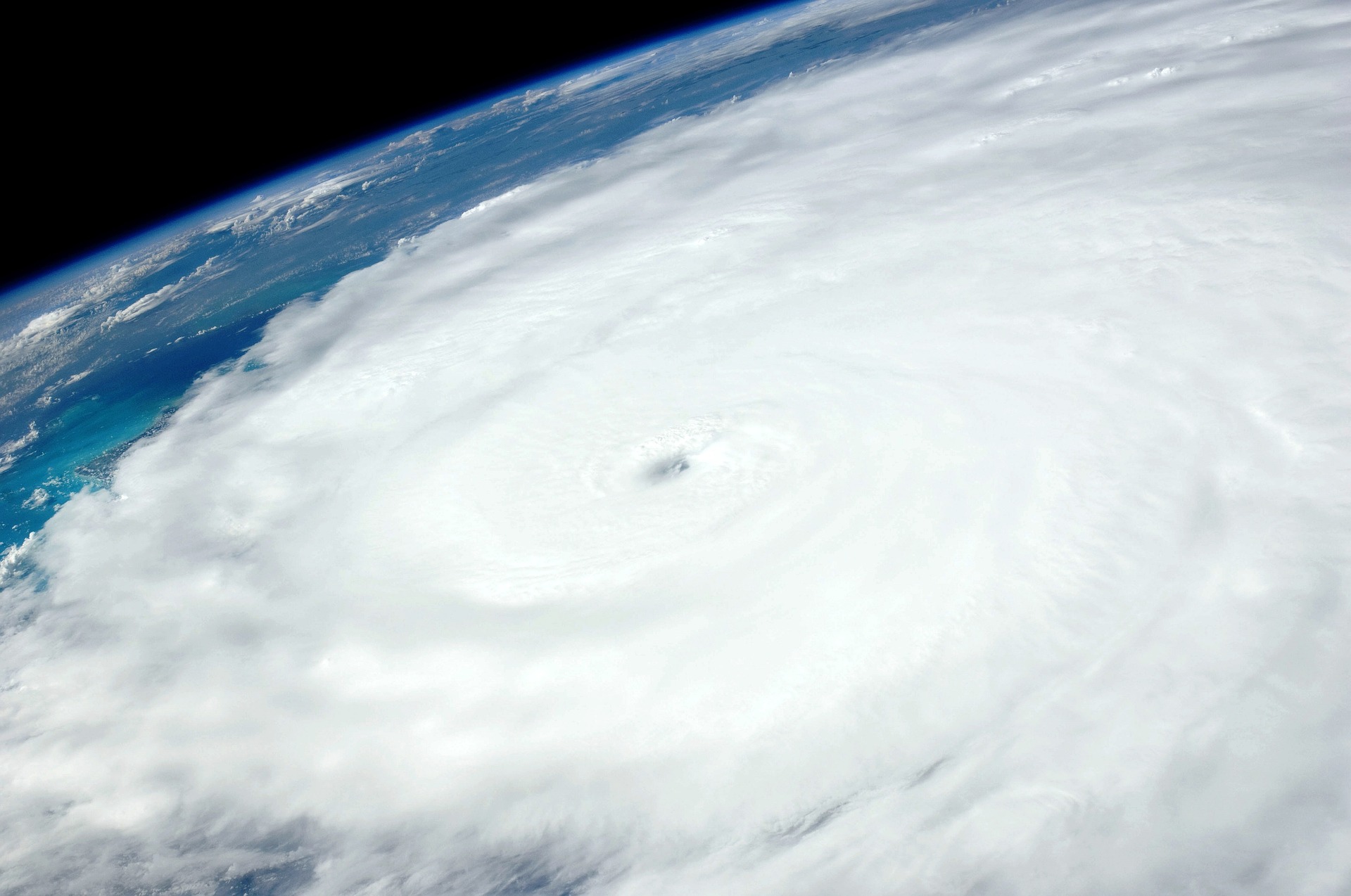 Hurricane seen from space with massive swirling cloud formation over ocean