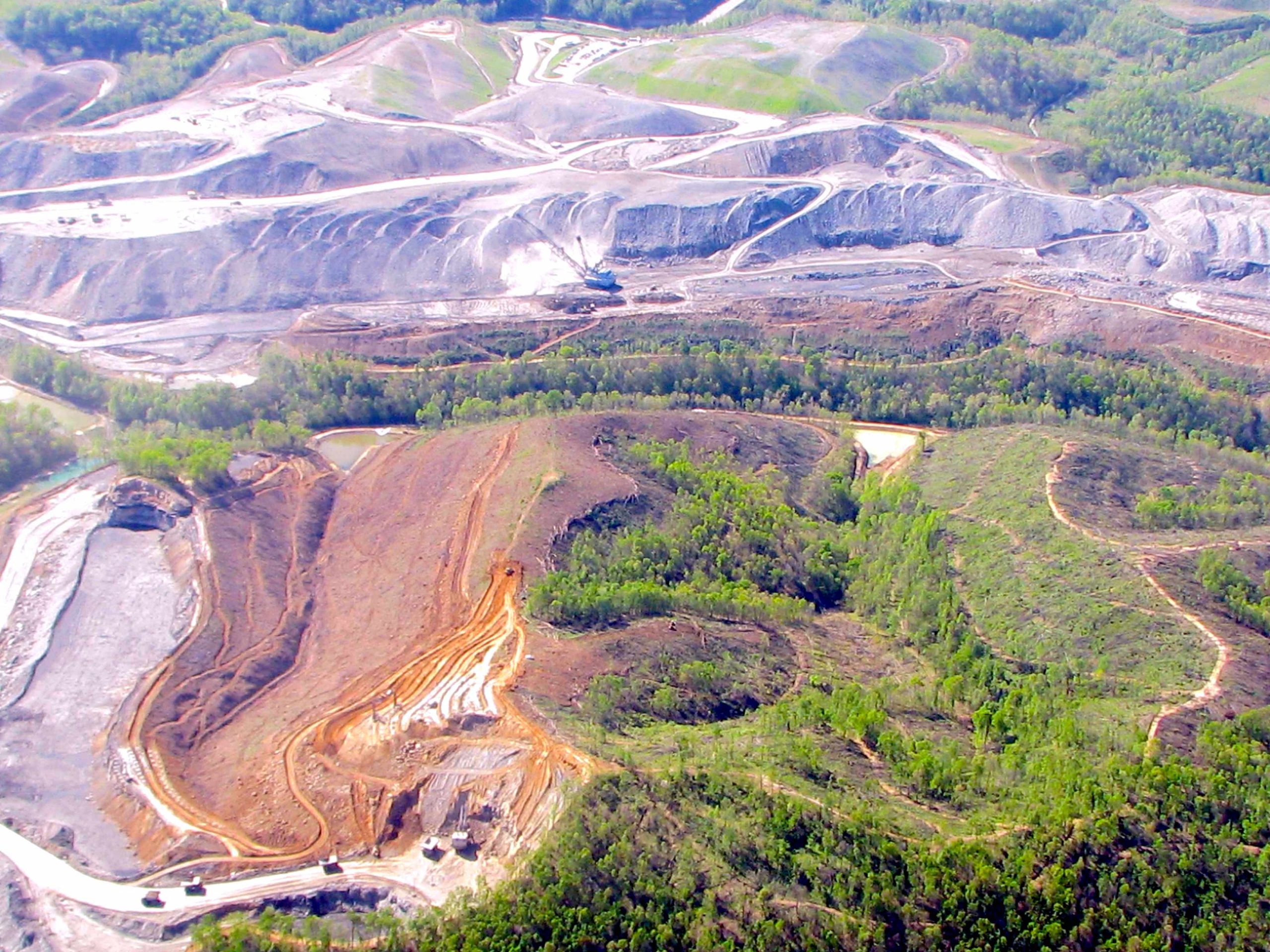 Aerial view of mountaintop removal mining with exposed earth and deforested land